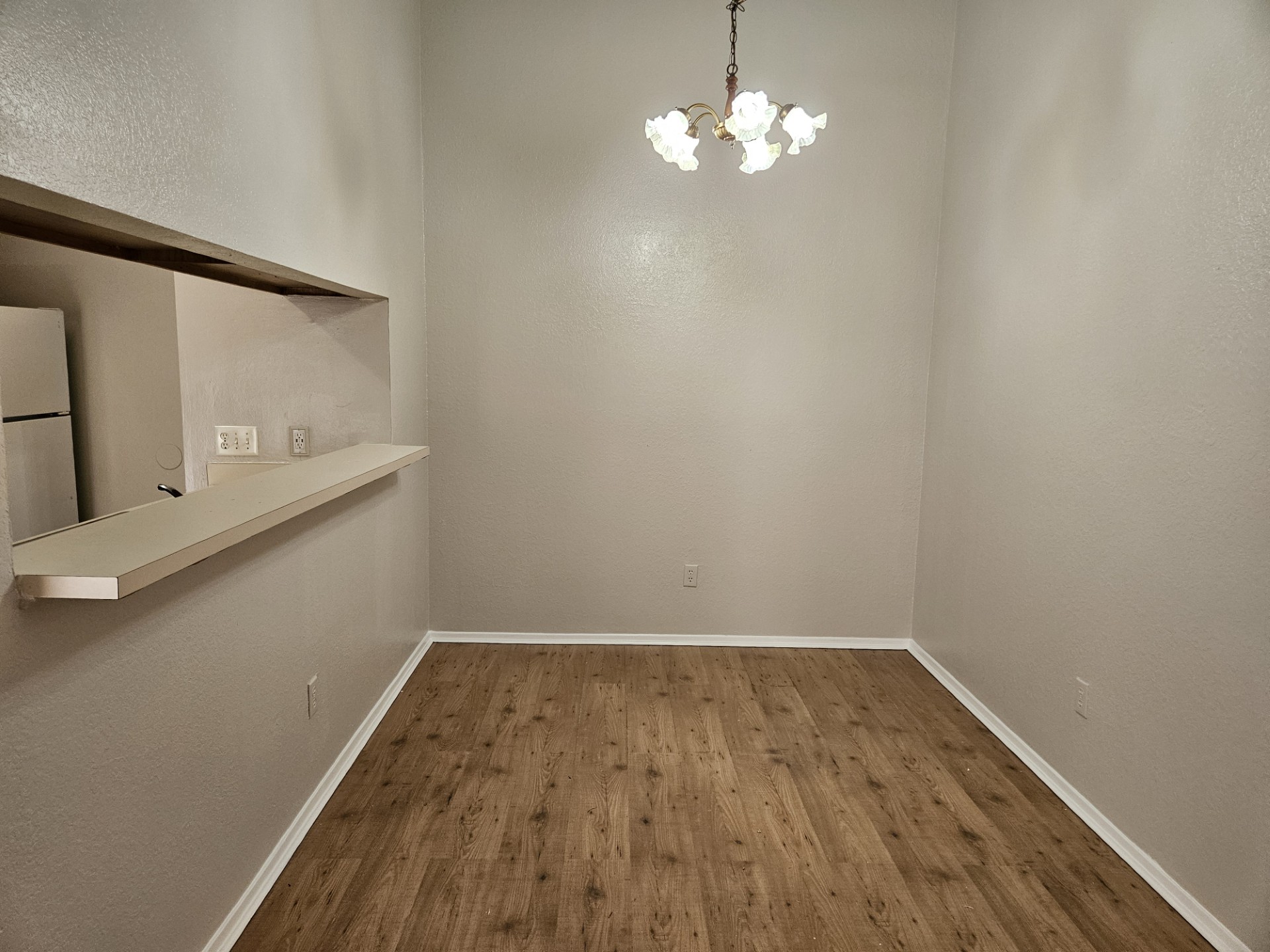 805 Lexington Road, Unit B Elgin, TX 78621 - Photo 2 of 11 A well-lit dining area features a pass-through to the kitchen and rich wood flooring.