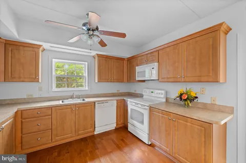 a kitchen with a sink cabinets and window