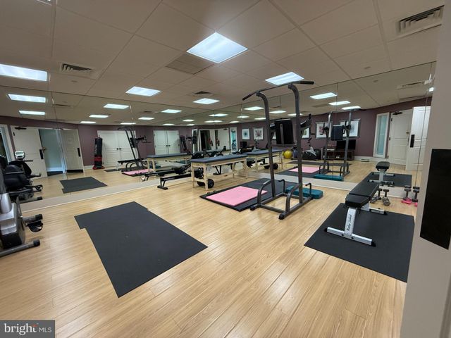 a front view of a building with a garden