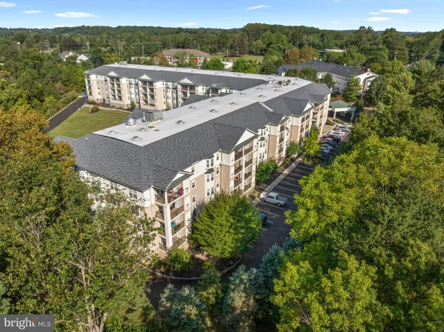 a front view of a residential apartment building with a yard
