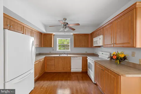a kitchen with stainless steel appliances a sink a stove a refrigerator and cabinets