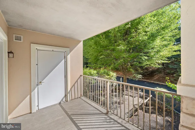a view of balcony with wooden floor and fence