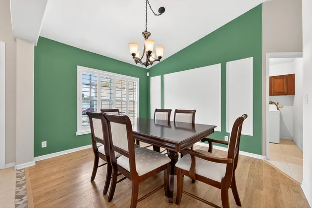 a bedroom with two beds and a chandelier