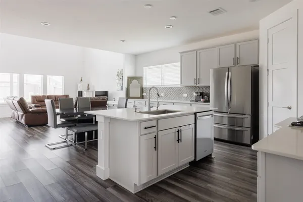 a kitchen with refrigerator and cabinets