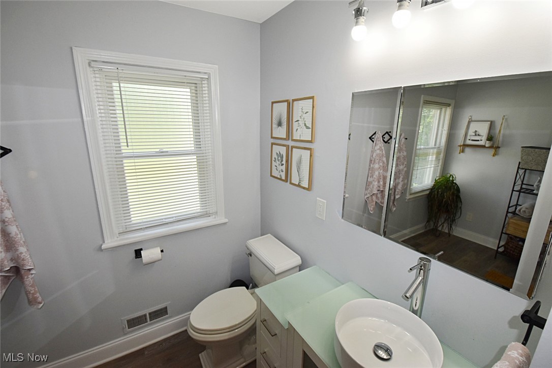 1388 Ford Road Lyndhurst, OH 44124 - Photo 16 of 39 Bathroom with vanity, toilet, and hardwood / wood-style flooring