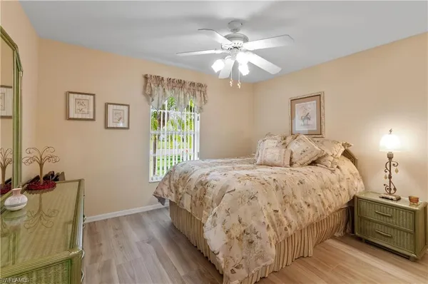 a spacious bedroom with a bed and a chandelier