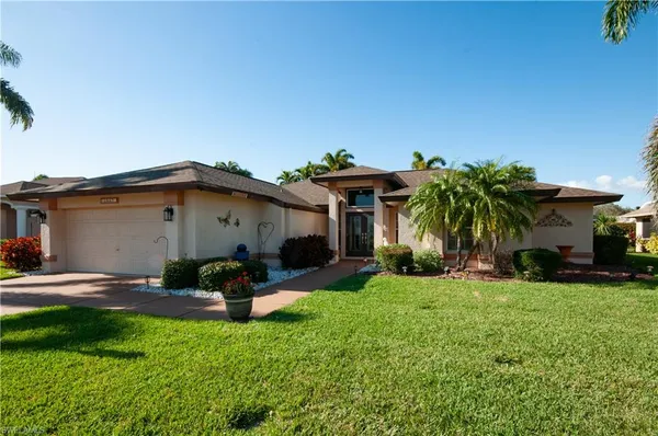 a front view of a house with a yard and garage