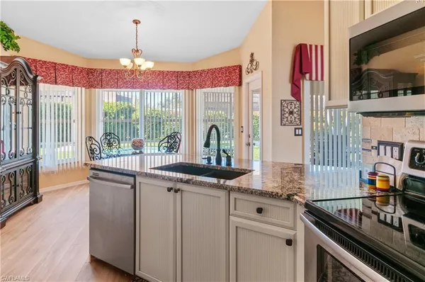 a kitchen with stainless steel appliances granite countertop a stove and a sink