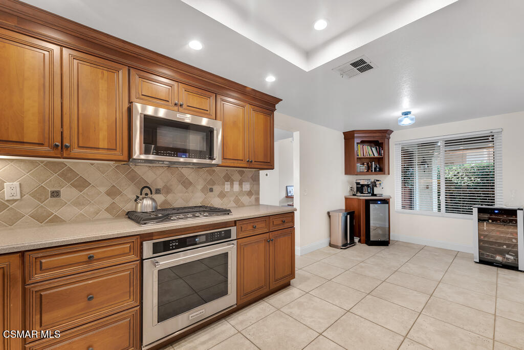 16 Valley Crest Road Simi Valley, CA 93065 - Photo 14 of 41 a kitchen with stainless steel appliances granite countertop a stove a sink and a microwave
