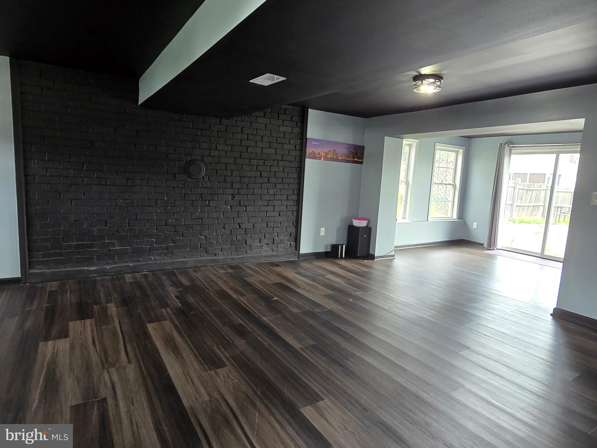 7513 Saffron Court Hanover, MD 21076 - Photo 34 of 42 an empty room with wooden floor and windows