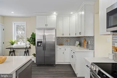 a kitchen with a refrigerator sink and stove