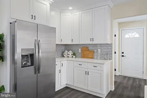 a kitchen with cabinets and stainless steel appliances