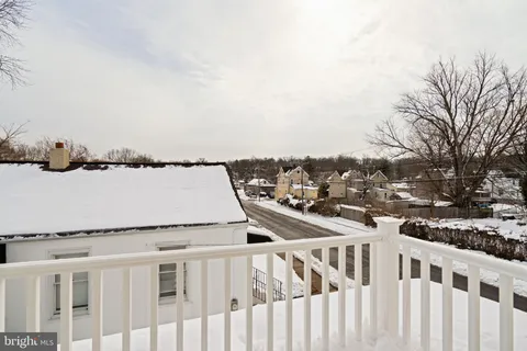a view of a balcony with wooden fence