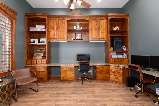 687 South 2080th Street East Springville, UT 84663 - Photo 8 of 149 Built-in wood cabinetry with integrated shelving and desk space, featuring stone-finish countertops and wood-finish flooring