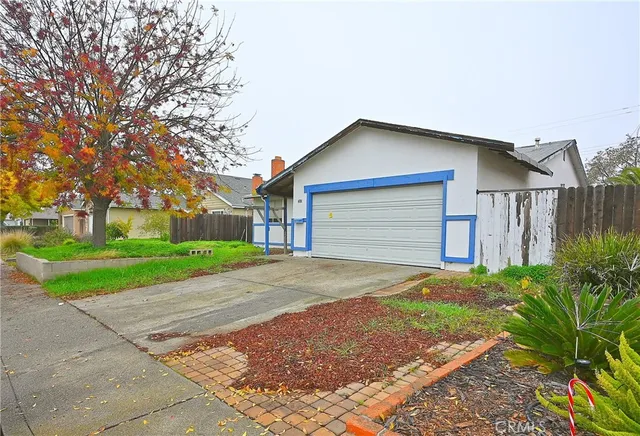 a front view of house with yard and green space
