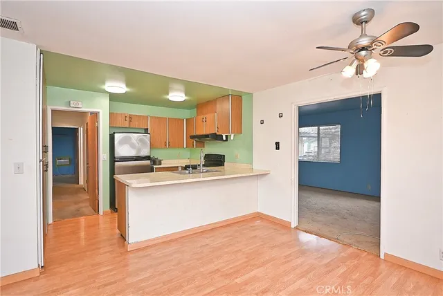 a view of kitchen with cabinets and wooden floor