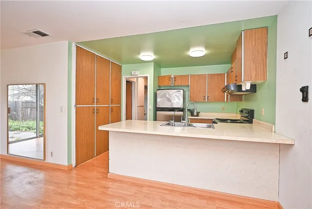 a kitchen with kitchen island a sink appliances and cabinets