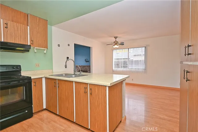 a kitchen with granite countertop a stove and a sink