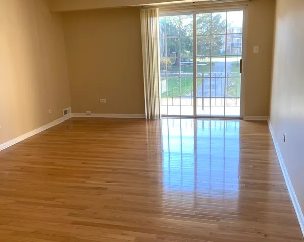 a view of a room with wooden floor and windows