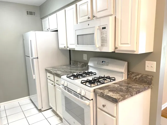 a kitchen with a stove a refrigerator and a sink