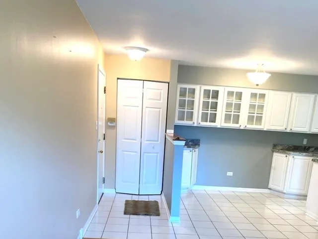 a view of a room with an empty space and a window