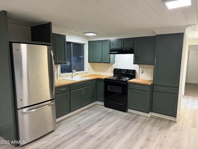 a kitchen with a refrigerator and a stove