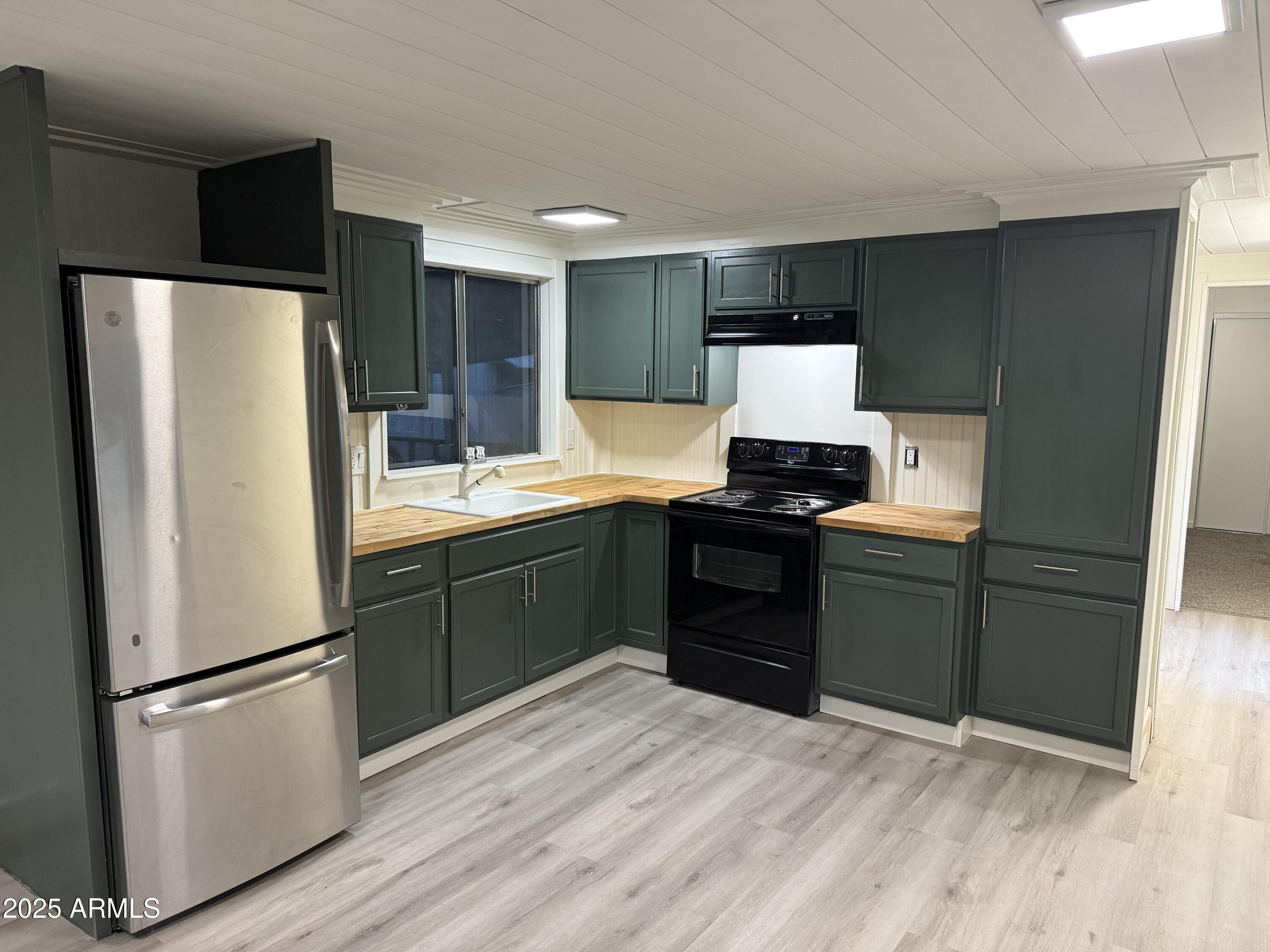 a kitchen with a refrigerator and a stove
