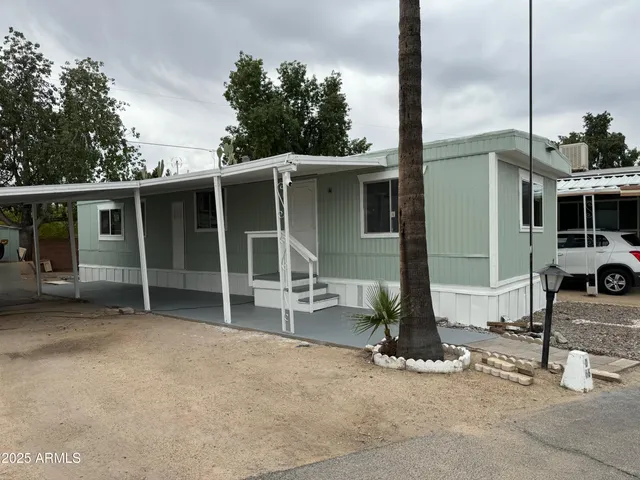 a view of a house with backyard porch and sitting area