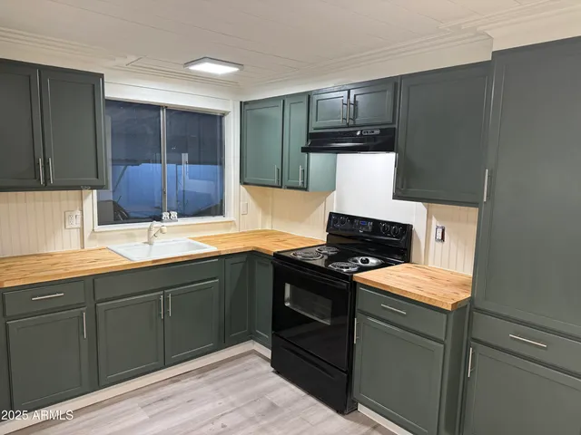 a kitchen with a sink and a stove