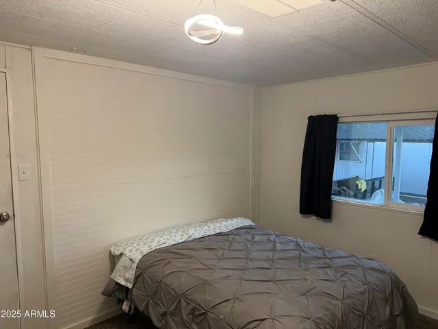 a bedroom with a bed and a mirror