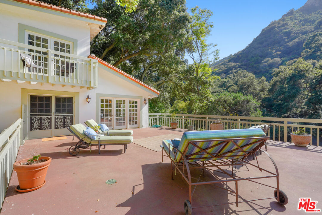 964 Old Topanga Canyon Road Topanga, CA 90290 - Photo 16 of 75 a view of a patio with couches table and chairs and potted plants