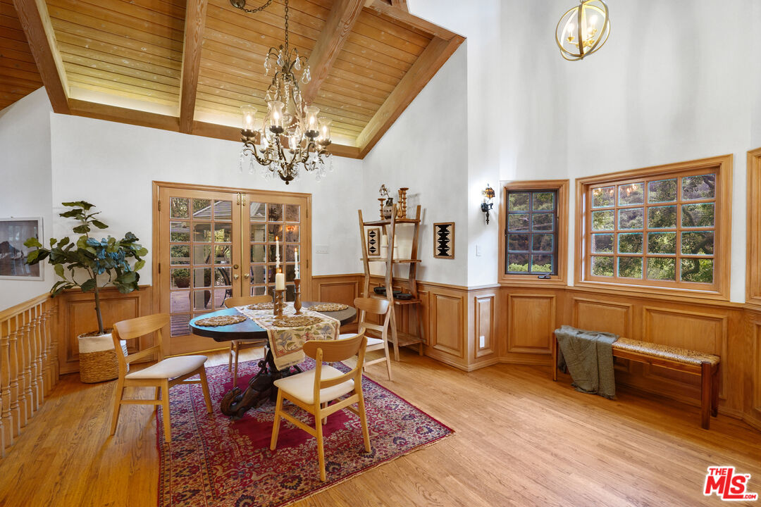 964 Old Topanga Canyon Road Topanga, CA 90290 - Photo 25 of 75 a dining room with wooden floor and a chandelier