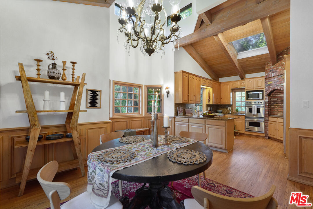 964 Old Topanga Canyon Road Topanga, CA 90290 - Photo 26 of 75 a dining room with furniture a kitchen view and wooden floor