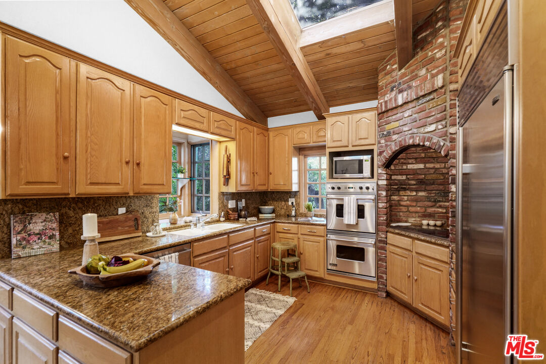 964 Old Topanga Canyon Road Topanga, CA 90290 - Photo 28 of 75 a kitchen with stainless steel appliances granite countertop a sink stove and cabinets