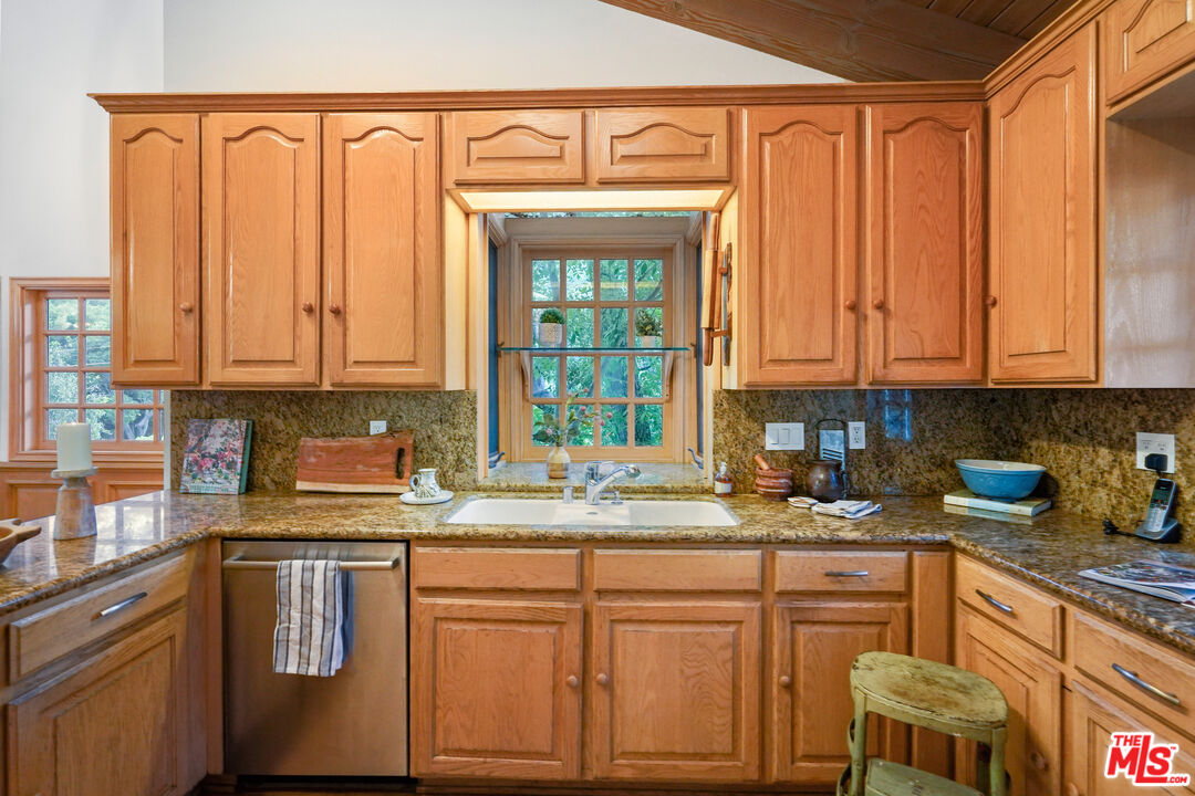 964 Old Topanga Canyon Road Topanga, CA 90290 - Photo 29 of 75 a kitchen with stainless steel appliances granite countertop a sink a refrigerator and cabinets