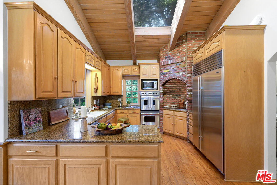 964 Old Topanga Canyon Road Topanga, CA 90290 - Photo 30 of 75 a kitchen with refrigerator and cabinets