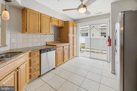 a kitchen with white cabinets and refrigerator