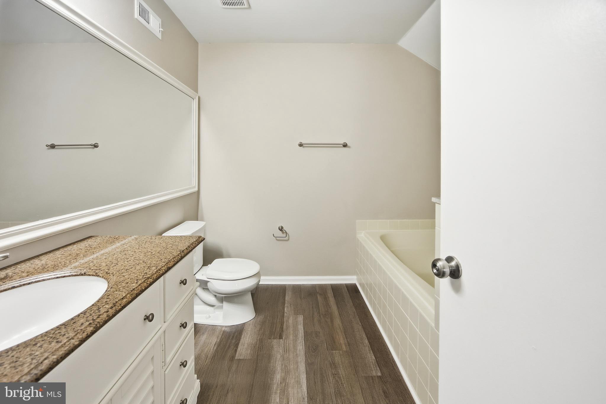 1401 Wharton Road Mount Laurel, NJ 08054 - Photo 36 of 40 a bathroom with a granite countertop toilet a sink and a mirror