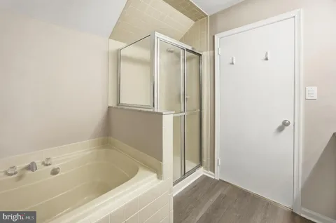 a bathroom with a bathtub and a shower