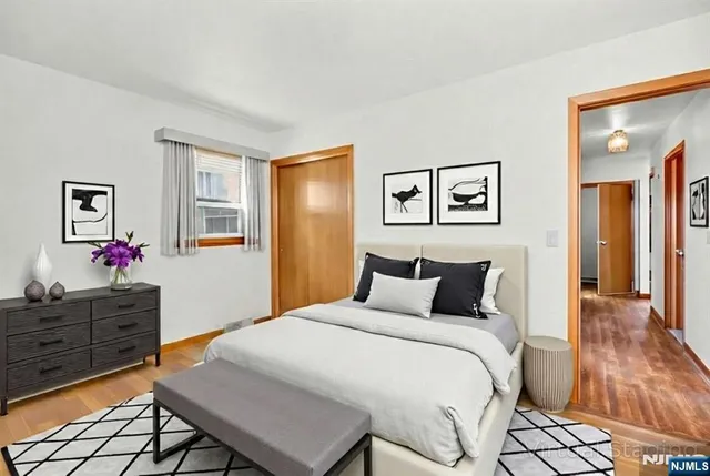 a bathroom with a granite countertop sink a toilet and mirror