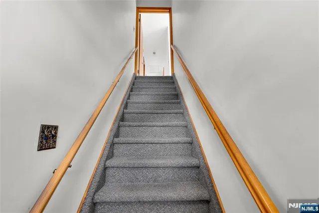 a front view of a house with a garden and deck