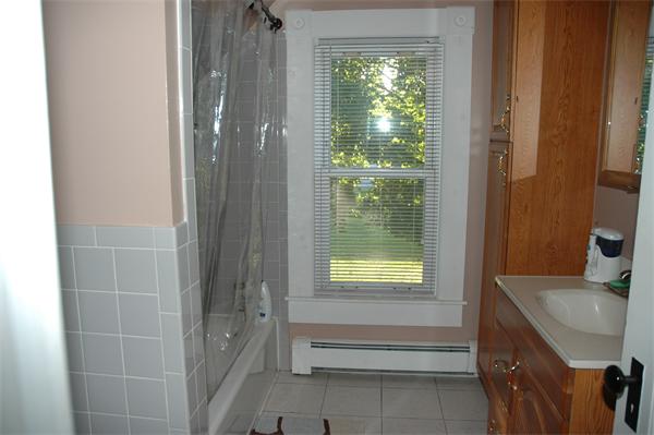 126 Mammoth Road Lowell, MA 01854 - Photo 18 of 23 a bathroom with a sink a toilet and shower