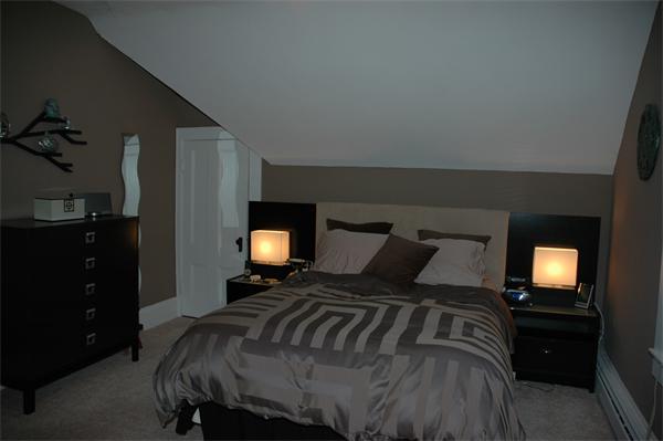 126 Mammoth Road Lowell, MA 01854 - Photo 20 of 23 a bedroom with a bed and wooden floor