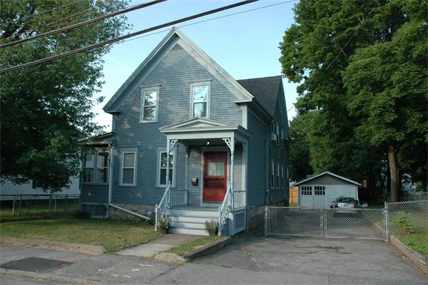 126 Mammoth Road Lowell, MA 01854 - Photo 4 of 23 a front view of a house with a garden