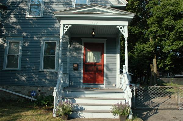 126 Mammoth Road Lowell, MA 01854 - Photo 5 of 23 a front view of a house with a yard