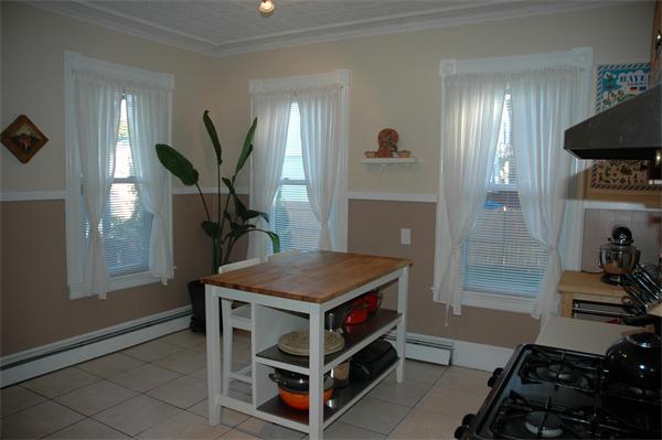 126 Mammoth Road Lowell, MA 01854 - Photo 7 of 23 a room with furniture and a chandelier