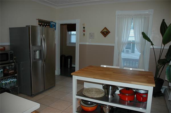 126 Mammoth Road Lowell, MA 01854 - Photo 8 of 23 a kitchen with stainless steel appliances granite countertop a refrigerator and a stove