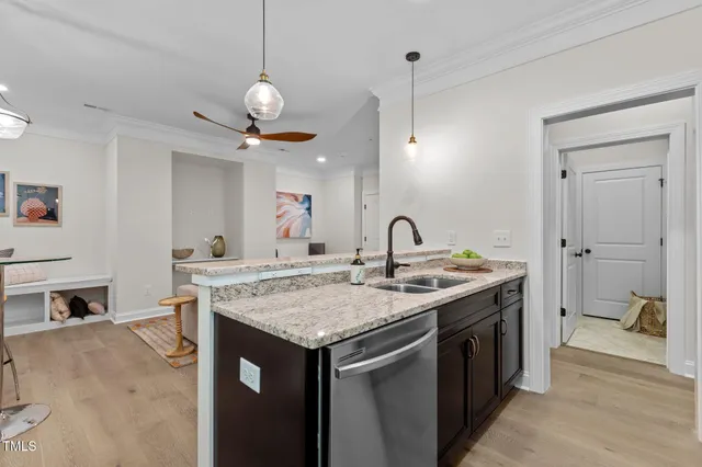 a view of a kitchen island a sink and dishwasher