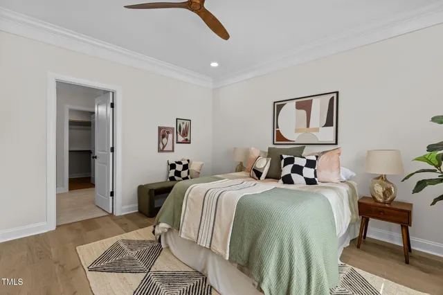 a bedroom with a bed and a chandelier