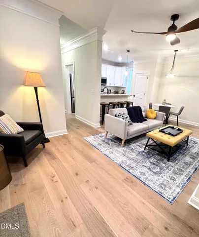 a living room with furniture rug and a table
